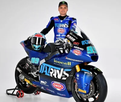 Moto Gp Pilot Adrian huertas behind his Motorcycle