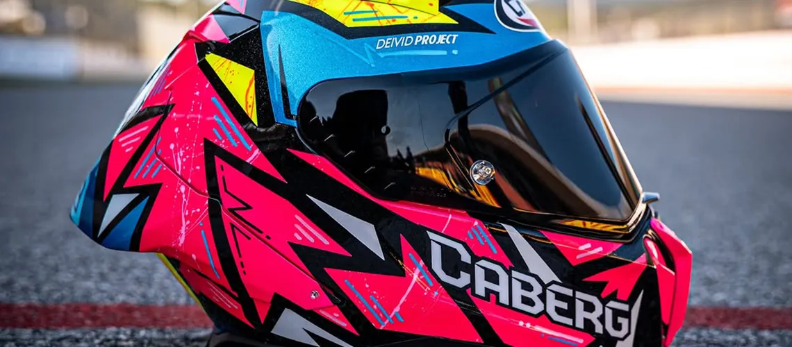 Photo of a mootorcycle helmet with sponsors logos on it